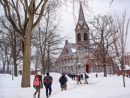 UMass Winter Chapel covered in snow with students walking showing continuity planning