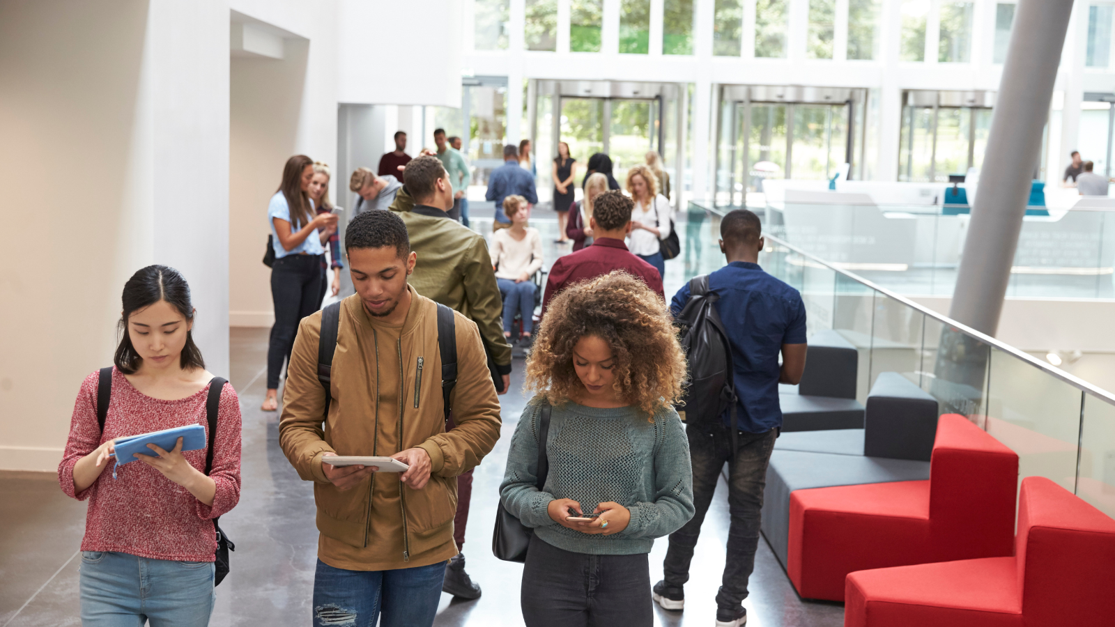 students walking on campus in building during academic continuity plan