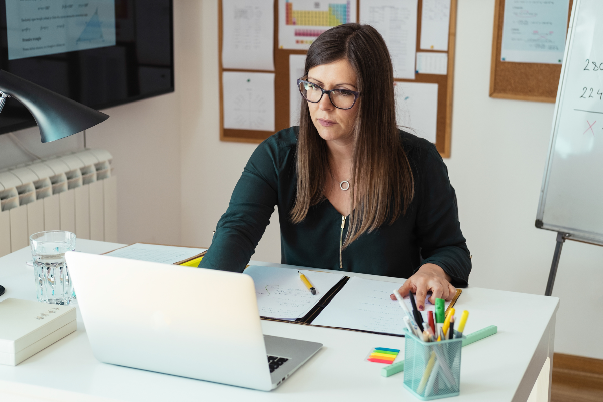 Female professor working on laptop equitizing her asynchronous online methods course