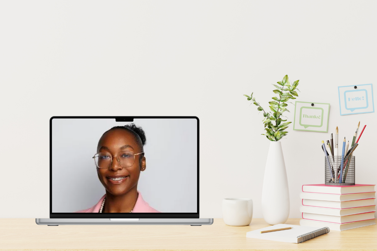 Digital Learning student intern headshot on laptop on desk with decorative items.