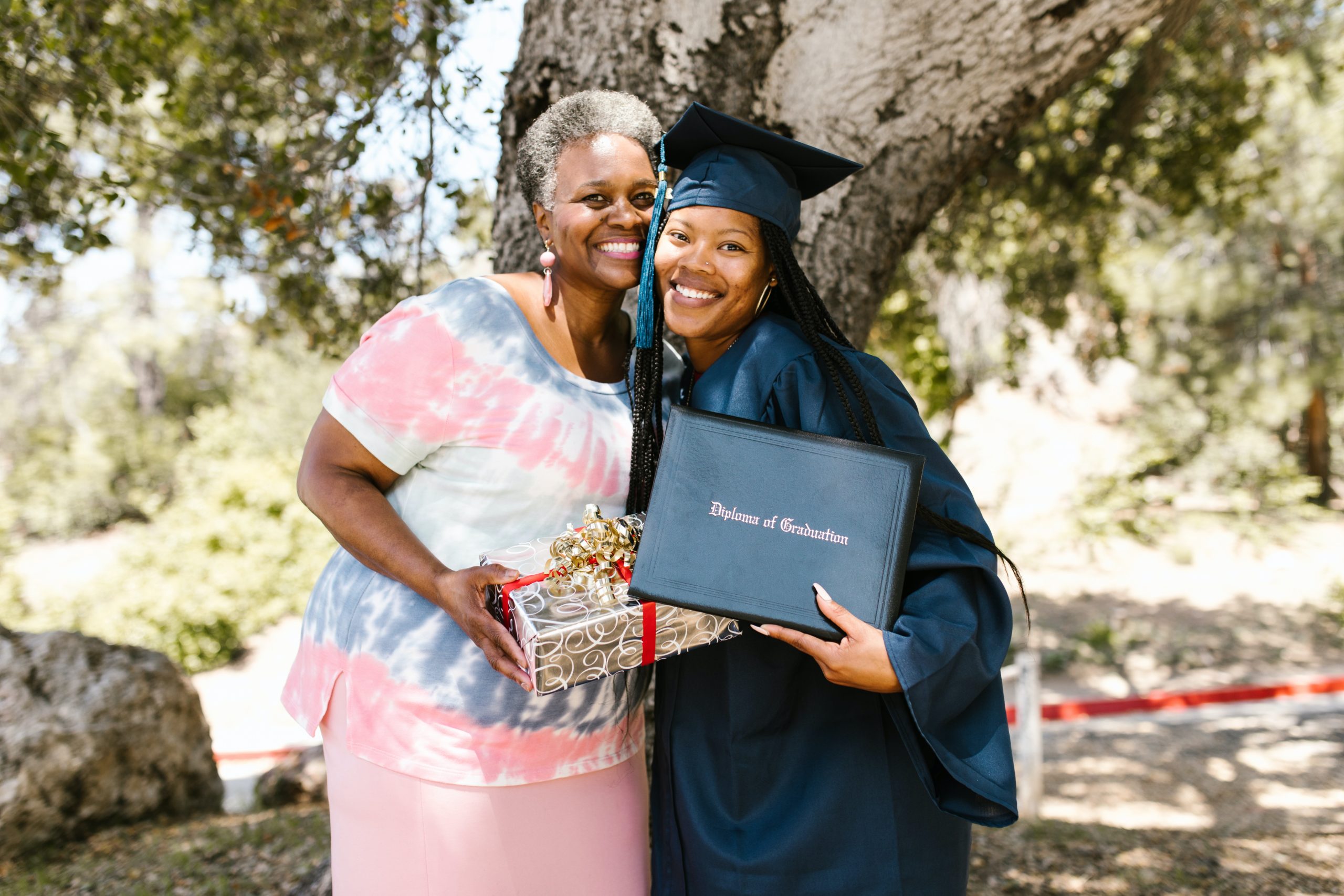 first-generation student at graduation with mother and gift