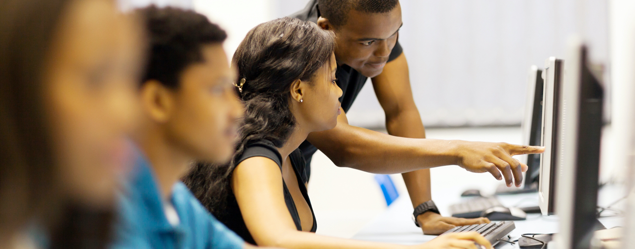 Students helping each other in a computer lab